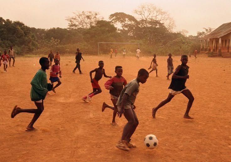 Football on a red dirt pitch